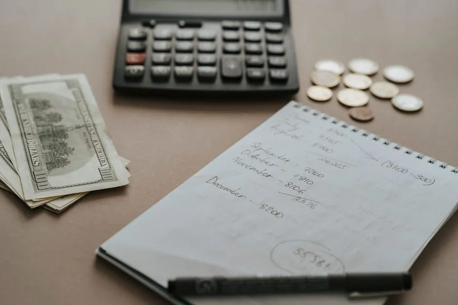 A notebook and pen laid out for tracking household budget spending